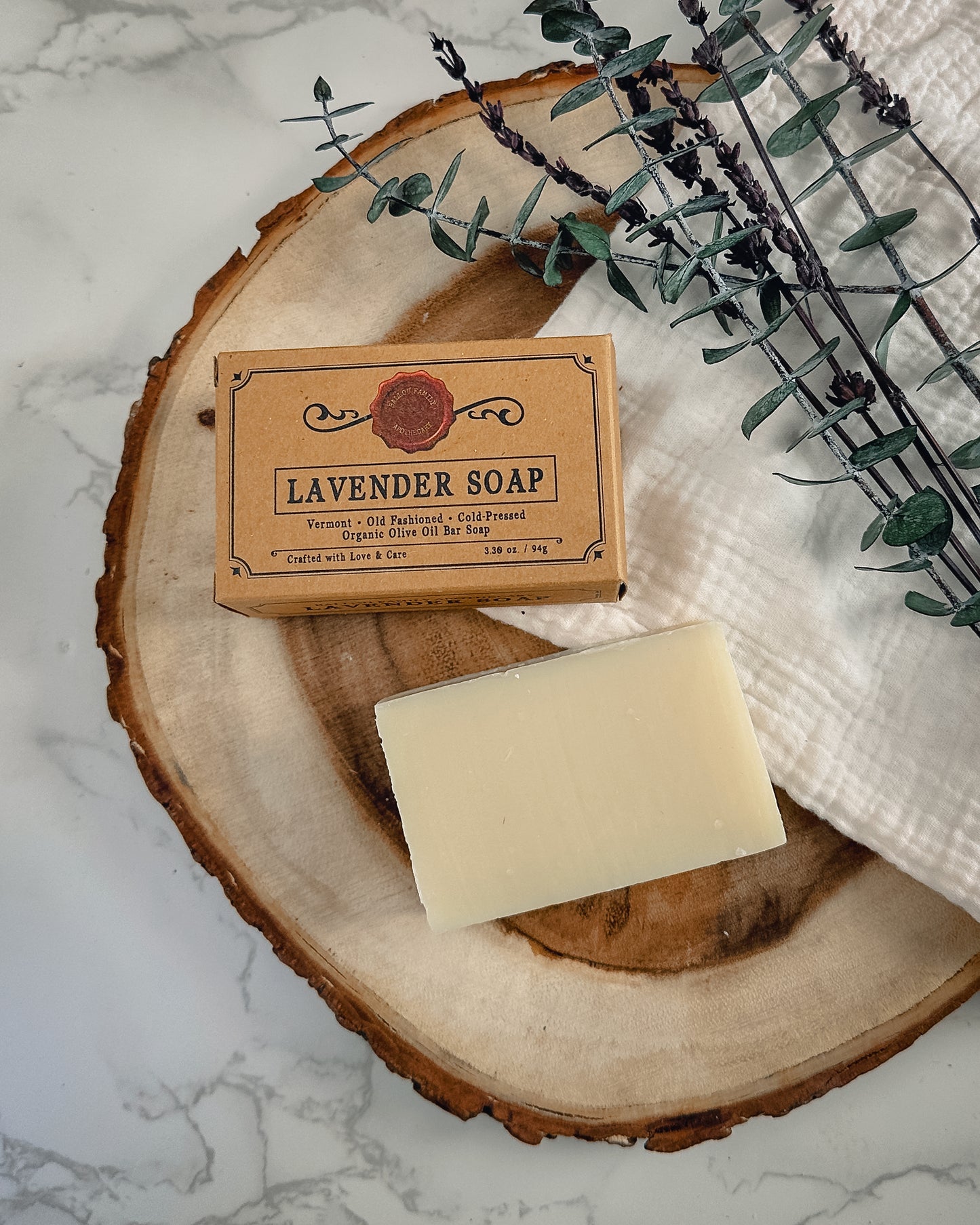 Box of Lavendar Soap with Natural Soap Bar next to it