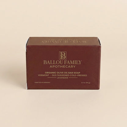 Ballou Family Apothecary soap bar packaging on a beige background