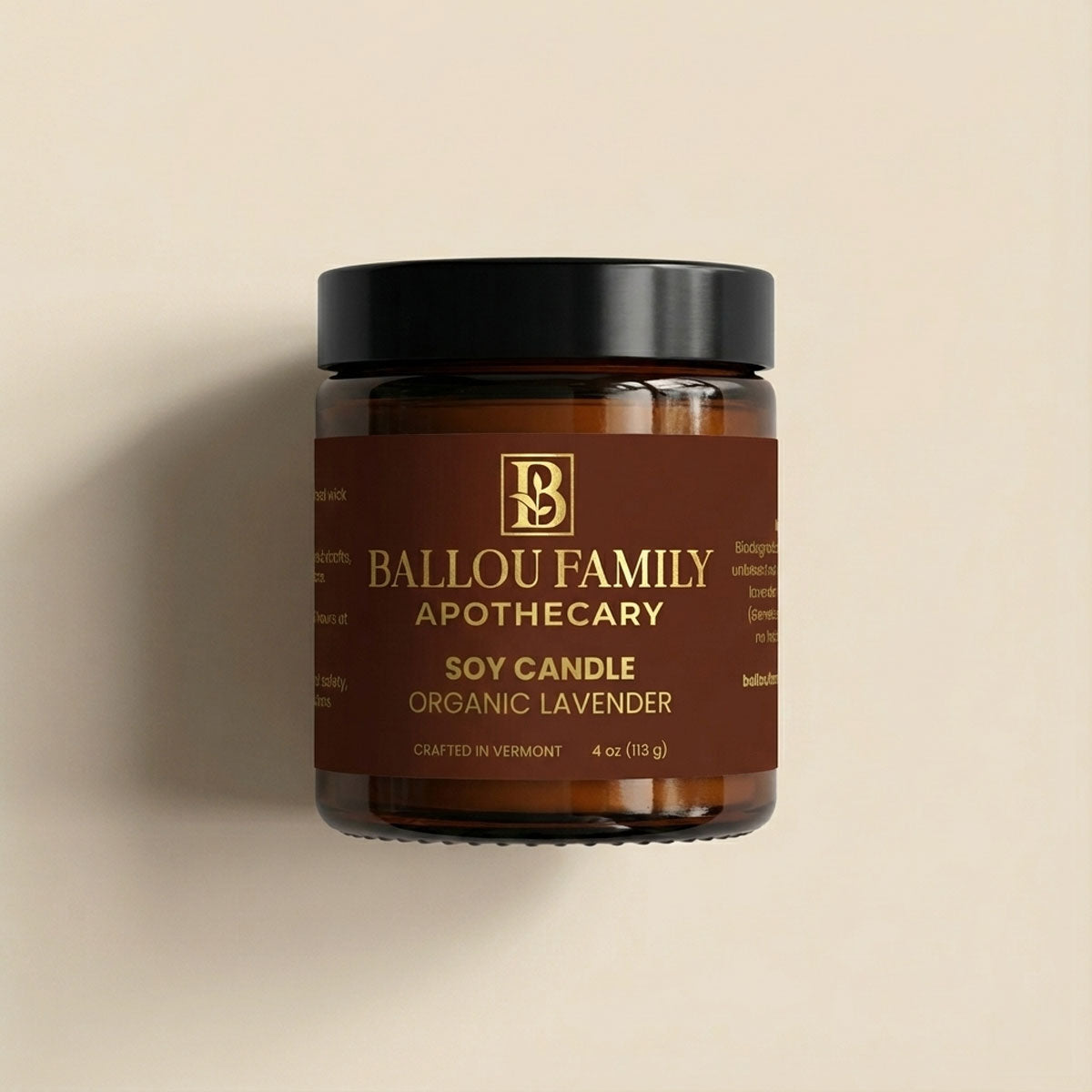 Soy candle jar with Ballou Family Apothecary branding on a beige background