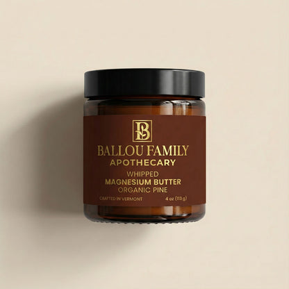 Jar of Ballou Family Apothecary whipped magnesium butter on a beige background