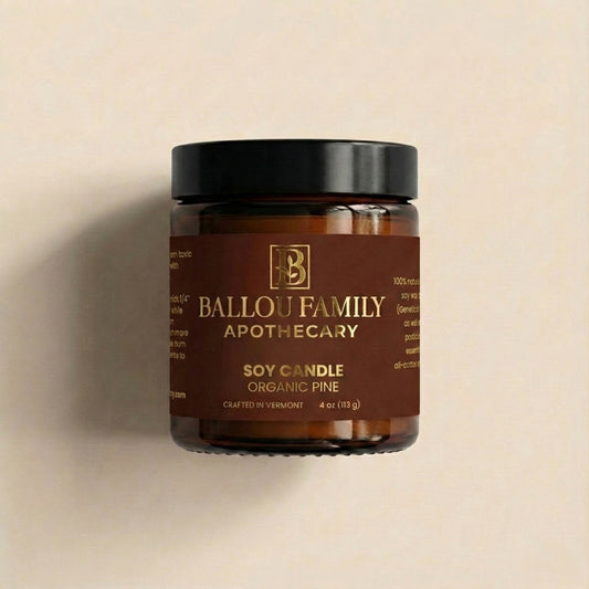 Jar of Ballou Family Apothecary soy candle on a beige background
