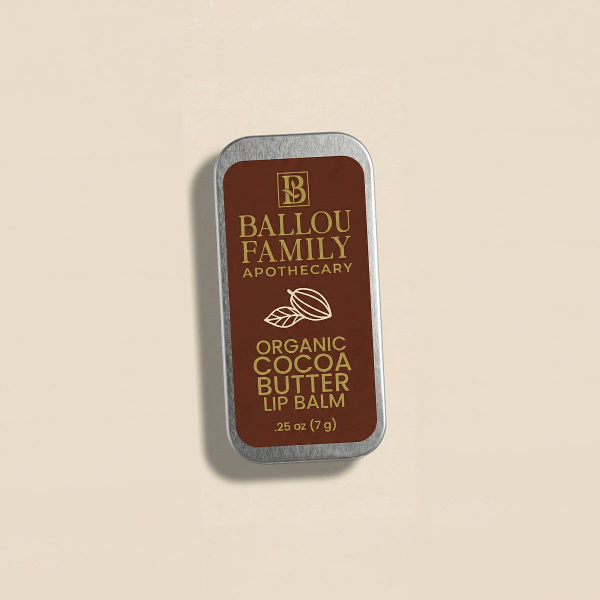 Ballou Family Apothecary organic cocoa butter lip balm tin on a beige background