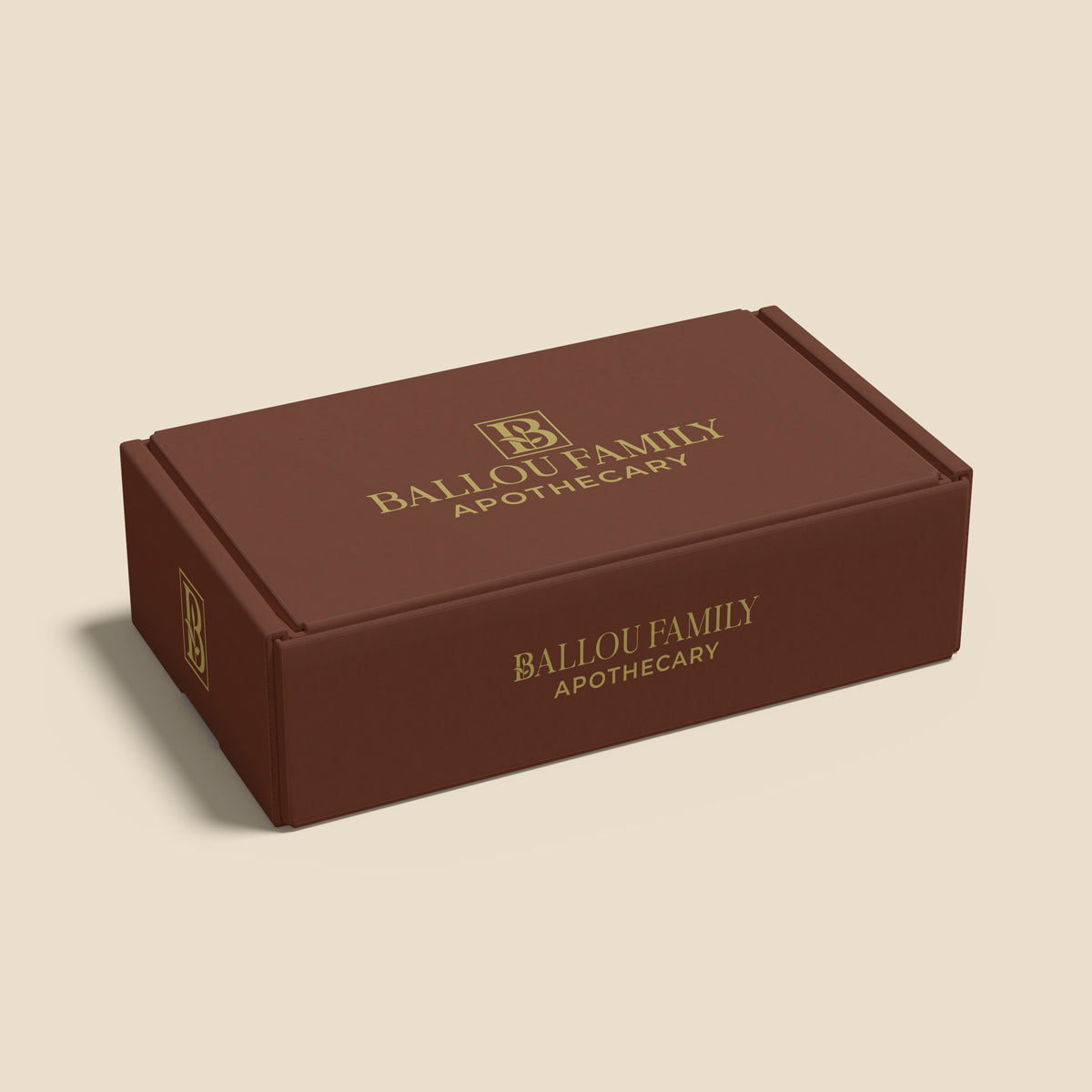 Brown gift set box with 'Ballou Family Apothecary' branding on a beige background