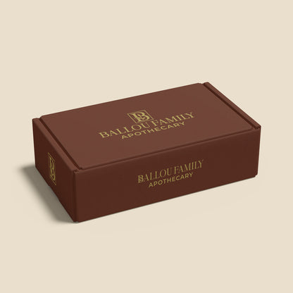 Brown gift set box with 'Ballou Family Apothecary' branding on a beige background