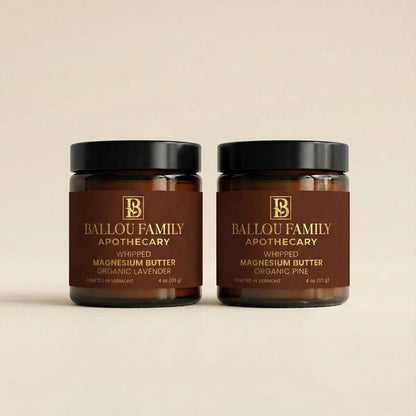 Two jars of Ballou Family Apothecary whipped magnesium butter on a beige background
