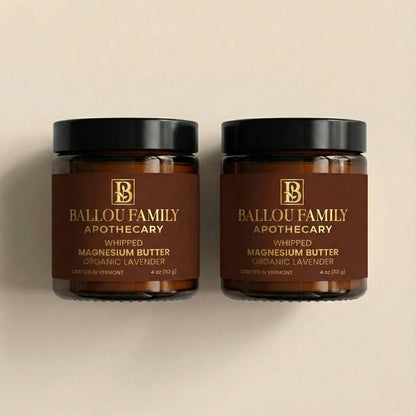 Two jars of Ballou Family Apothecary whipped magnesium butter on a beige background
