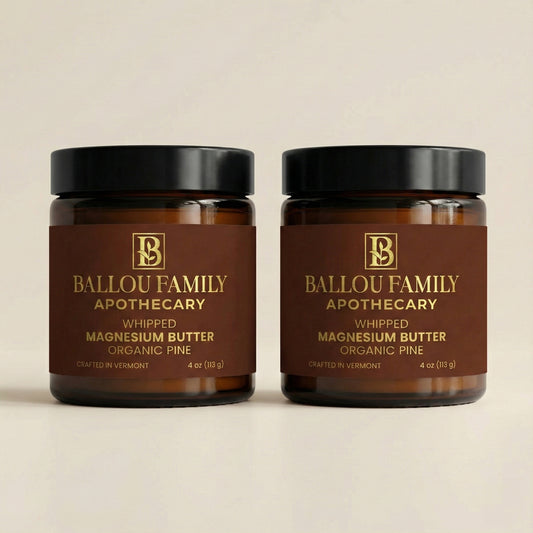 Two jars of Ballou Family Apothecary whipped magnesium butter on a beige background