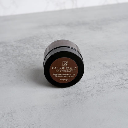 Ballou Family Apothecary magnesium butter container on a gray surface