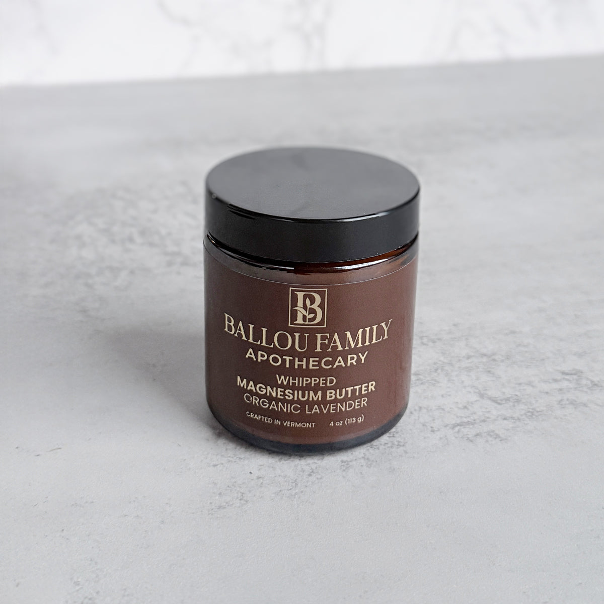 Jar of Ballou Family Apothecary whipped magnesium butter on a light gray background
