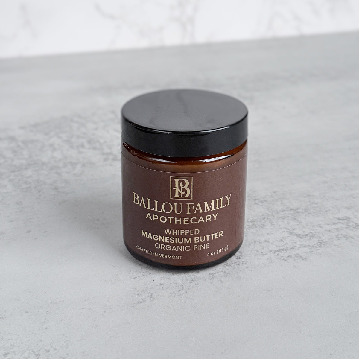 Jar of Ballou Family Apothecary whipped pine magnesium butter on a light gray background